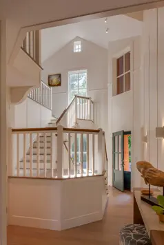 The entry and stair hall set the tone on arrival, creating a clear sense of structure and flow. The stair is a detailed work of art, anchoring the space with craftsmanship and presence.