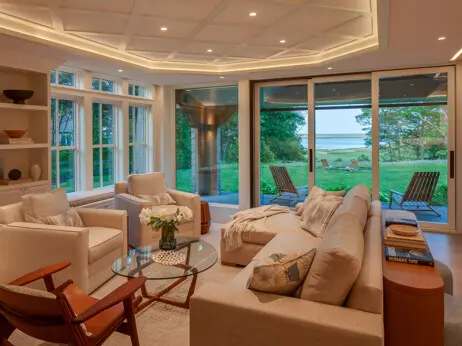 The living room at "Whalewatch." Built-ins, ceiling details, and full height sliding doors add to the room's appeal.