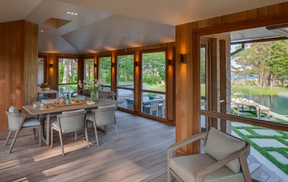 Expansive screened-in porch with outlook to outdoor living spaces and the view.