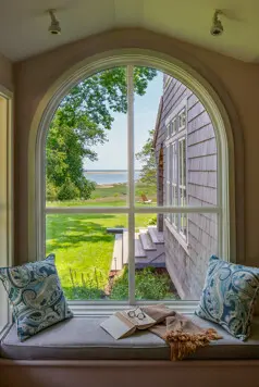 Window seat in the office with a view out to the ocean.