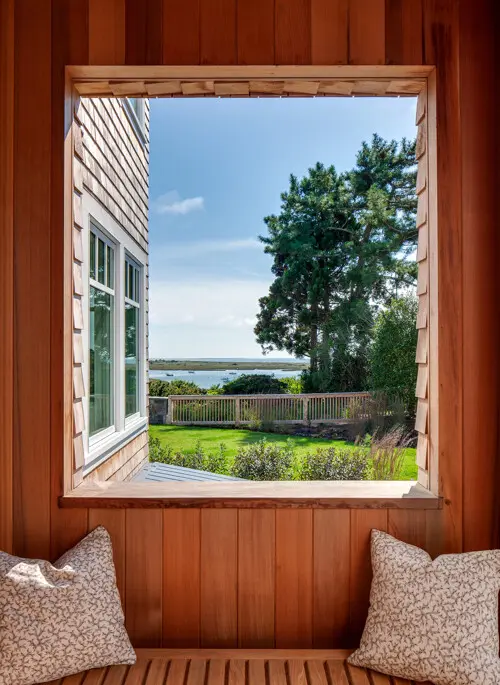 The mudroom porch is a covered space to enjoy outlook to the water.