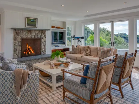 A fieldstone fireplace with a raised hearth anchors the living room.