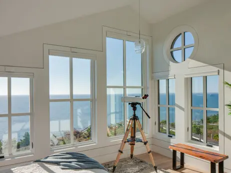 The primary bedroom takes full advantage of the view and has light from multiple directions.