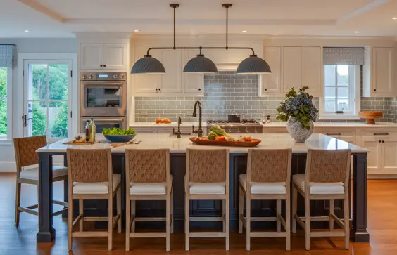 The new kitchen is open to the adjacent dining and living spaces. It has a coastal feel with blues and whites, and features a large island for entertaining and everyday use.