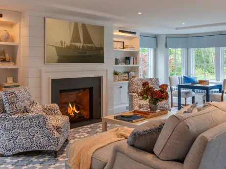 The living room was designed and built for relaxed family gatherings. Built-ins appear on both sides of the fireplace. Shiplap adds a touch of coastal elegance.