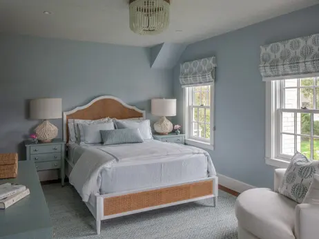 Bedrooms and bathrooms on the second floor provide ample sleeping space, while wallpapered ceilings and playful finishes give each room a distinct identity.